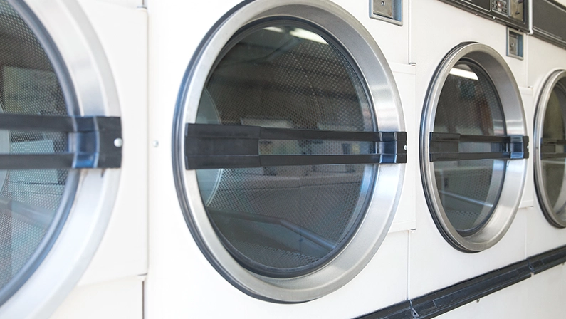 self-service laundry facilities concept - washing machines at laundromat