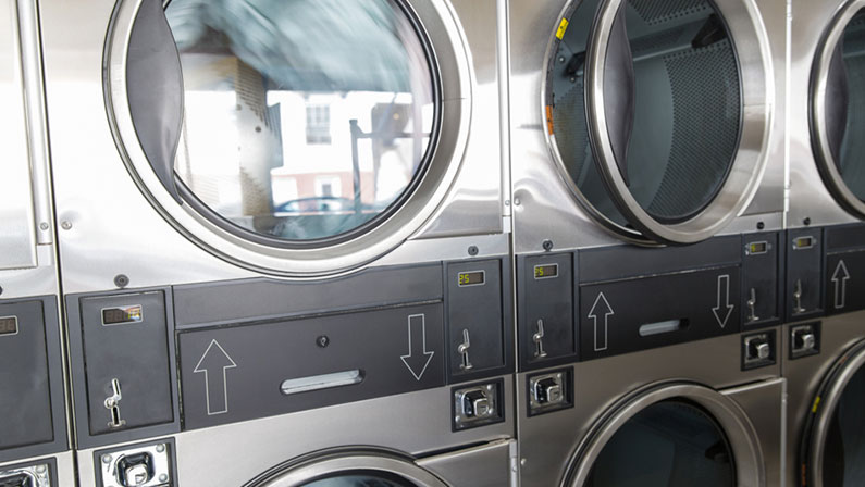 self-service laundry facilities concept - washing machines at laundromat