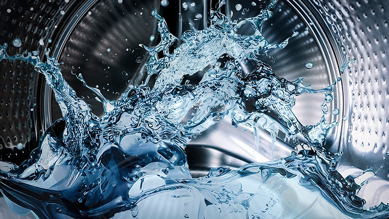 Washing machine drum with clean water flow and splashes. Laundry, washing powder concept.