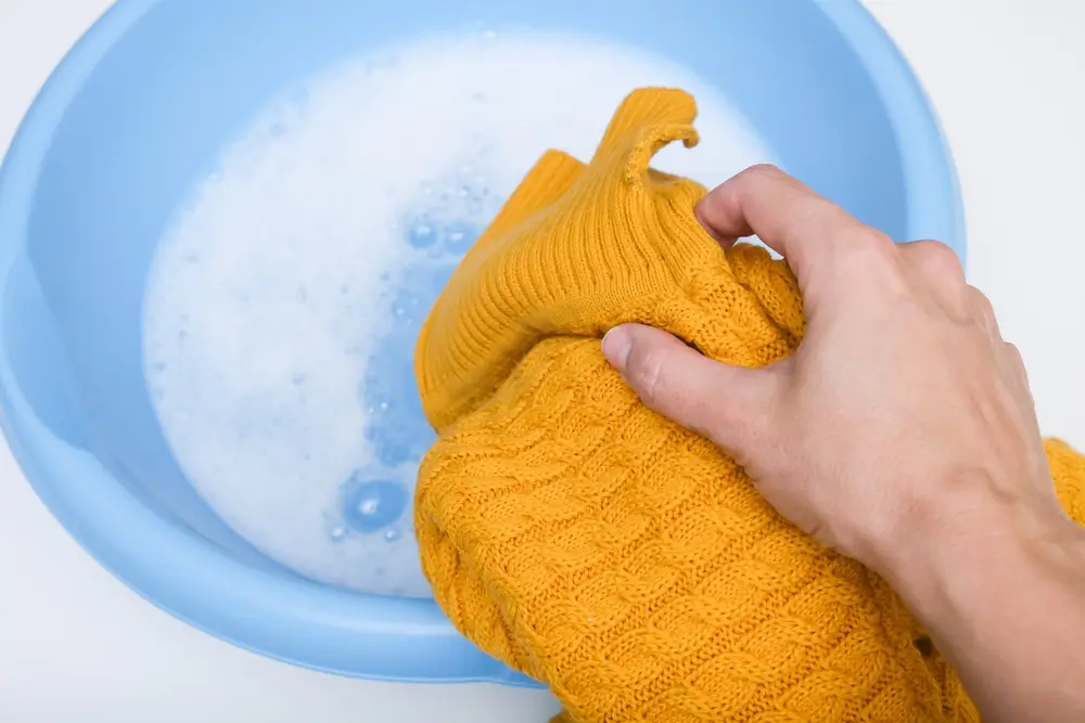 Hand washing of delicate woolen knitted clothes, sweaters concept
