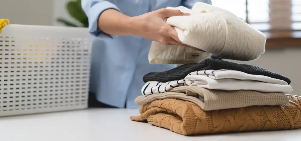 Laundry household work concept, asian woman working on fresh clean clothes.
