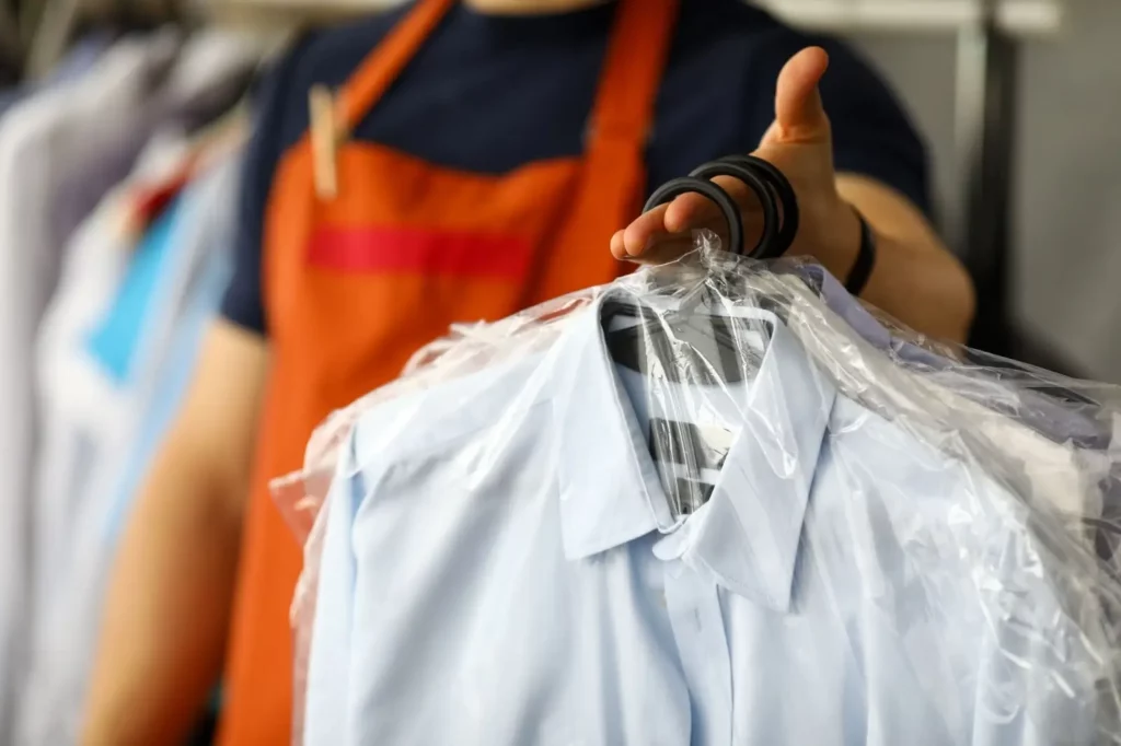 closeup of man holding bagged laundry