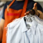 closeup of man holding bagged laundry