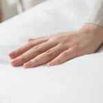Hand on soft duvet