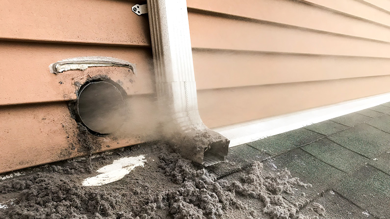 Lint collected from dryer machine is bloving out from vent during cleaning