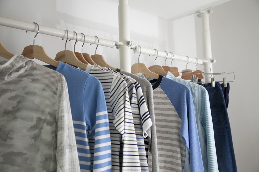 Many shirts hanging on a rack