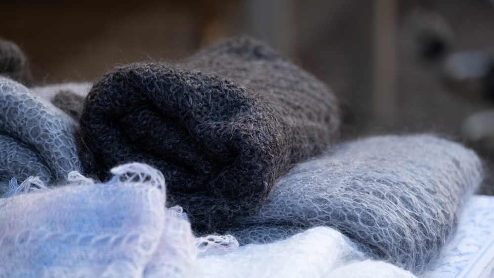 Close-up of folded mohair scarves