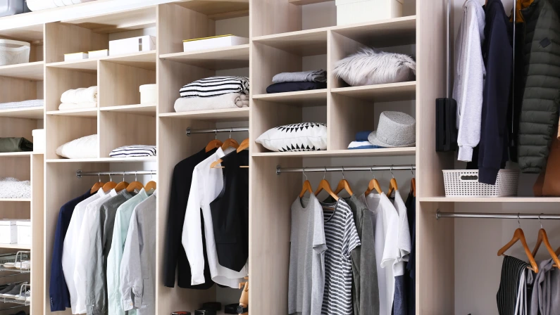 Stylish clothes, shoes and home stuff in large wardrobe closet