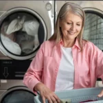 Senior woman washing clothes in laundromat using coin-operated machines for convenience