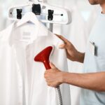 man Steaming Clean Clothes