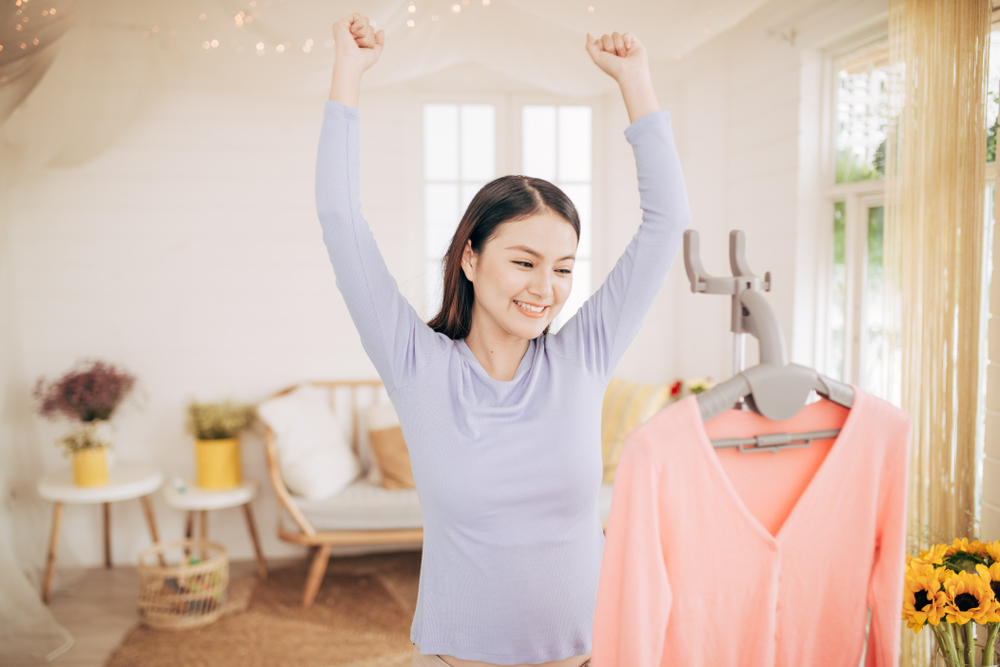 Funny foxy woman dancing with steamer iron. 